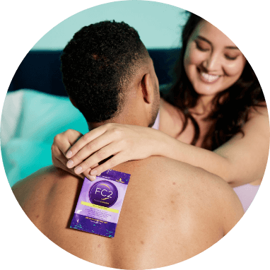 Dark Haired Girl holding a condom behind her partner's back