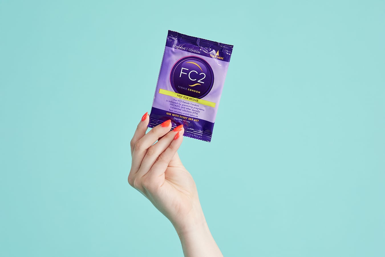 Closeup of hand holding a FC2 Female Condom sachet